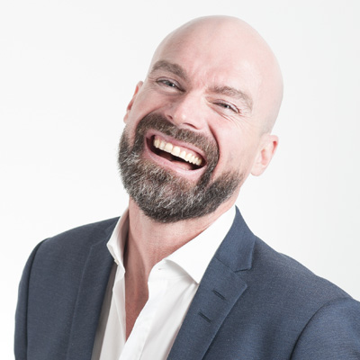 Bald man with beard in suit with smile