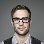 personal wears black glasses with suit